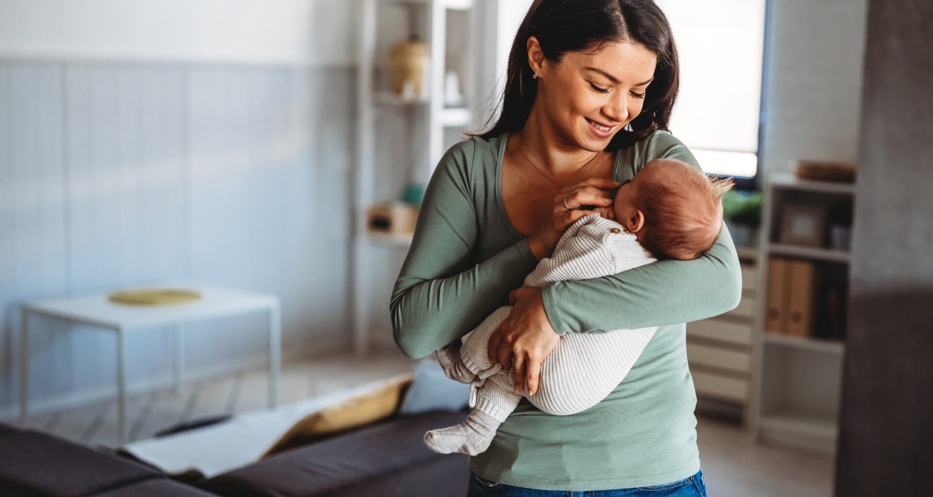 Happy mother holding adorable baby