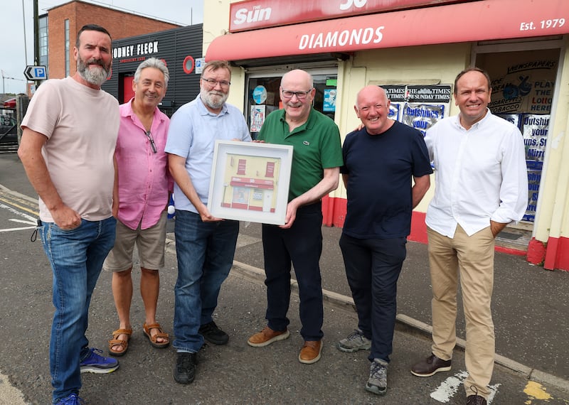 Press photographers present Ballymena Newsagent Eugene Diamond with a replica of his shop front by Dublin artist Nathan Wheeler for years of his dedicatiion to newspapers and photographers. PICTURE: OISIN CARSON