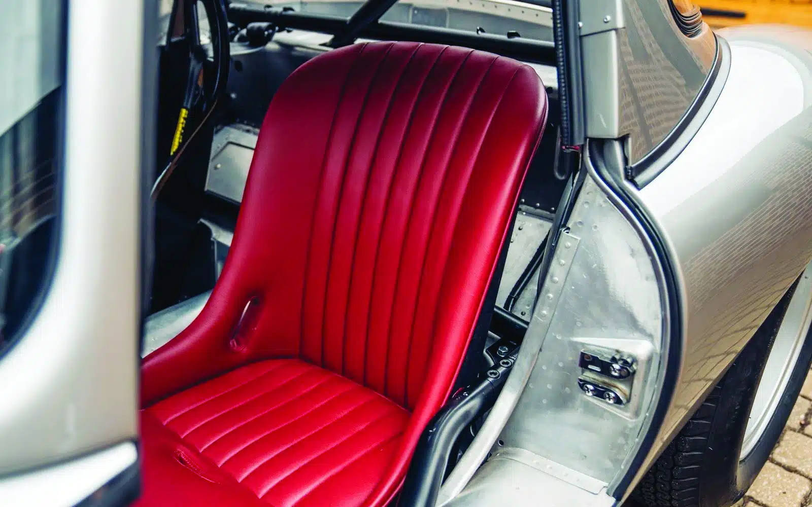Red driver's seat inside Jaguar E-type Lightweight continuation