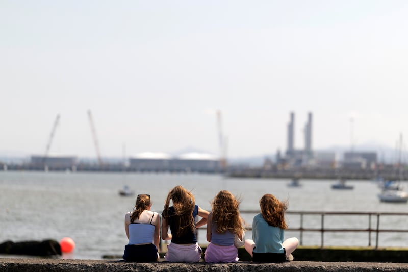 A group of girls sun themselves on the Clontarf promenade. Photograph: Chris Maddaloni