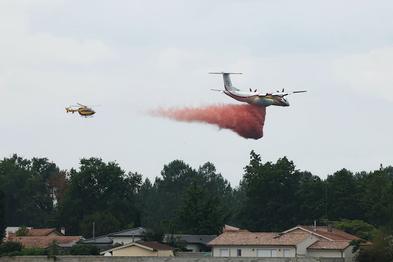 An aircraft dropping fire retardant over a forest near Marcheprime, 30km from Bordeaux, on Monday. Photograph: Alain Jocard/AFP/Getty Images