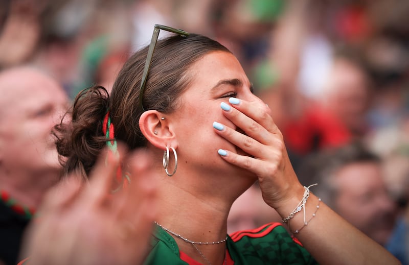 A Mayo supporter celebrates after their historic win in Croke Park against Kerry on Sunday. Photo: INPHO/Tom Maher