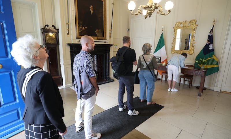 People queue to sign the book of condolences on Thursday. Photograph: Alan Betson 

