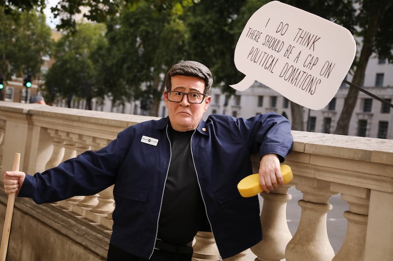 A demonstrator from pressure group 'Clean up Westminster' is dressed as Andy Burnham on Whitehall. Photograph: Alishia Abodunde/Getty Images