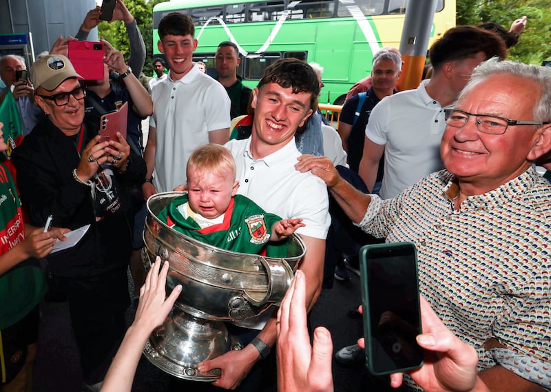 Jack Coyne with a young fan in the Sam Maguire Cup at Heuston Station. Photo: INPHO/Grace Halton