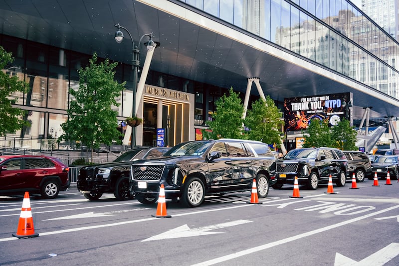 Queues of black SUVs outside Madison Square Garden as guests arrive for the wedding festivities. Photograph: Jutharat Pinyodoonyachet/The New York Times
                      