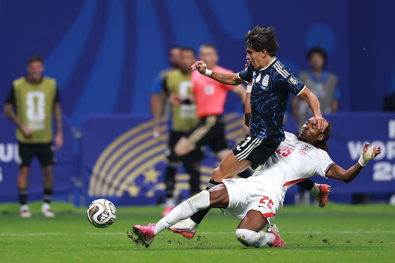Djed Spence of England makes a tackle against Giuliano Simeone of Argentina. Photograph: Elsa/Getty