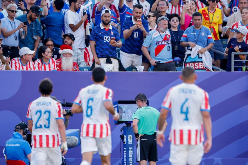 Referee Ilgiz Tantashev uses VAR to help him make up his mind during the World Cup meeting between France and Paraguay. Photograph: Jean Catuffe/Getty Images