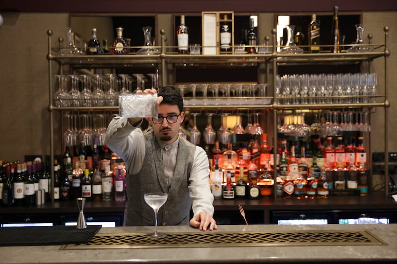 Mixologist Carlos Loubet prepares a dry martini