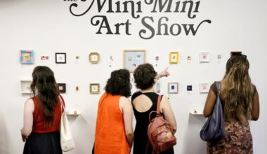 People explore “The Mini Mini Art Show” at At My House on Fourth Street in Philadelphia on July 24, 2026. Every artwork in the exhibition measures 1.5 inches by 1.5 inches — the size of a postage stamp.