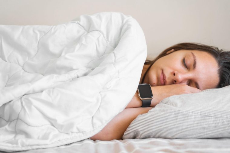 This is a generic photo of a young woman sleeping peacefully in bed while wearing a smartwatch. See PA Feature WELLBEING Sleep. WARNING: This picture must only be used to accompany PA feature WELLBEING Sleep PA Photo. Picture credit should read: Alamy/PA. NOTE TO EDITORS: This picture must only be used to accompany PA Feature WELLBEING Sleep.