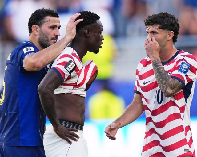 United States' Folarin Balogun (20) gets a pat on the head from Bosnia's Sead Kolasinac (5) as United States' Christian Pulisic (10) stands by after receiving a red card during the World Cup round of 32 soccer match between the United States and Bosnia in Santa Clara, Calif., near San Francisco, Wednesday, July 1, 2026. (AP Photo/Martin Meissner)