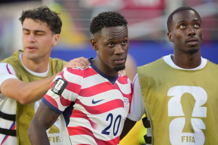 SANTA CLARA, CALIFORNIA - JULY 1: Folarin Balogun #20 of United States is comforted by Giovanni Reyna #7 and Timothy Weah #21 walks off the field after being red carded during the second half against Bosnia And Herzegovina during a FIFA World Cup 2026 Round Of 32 match at San Francisco Bay Area Stadium on July 1, 2026 in Santa Clara, California. (Photo by John Todd/ISI Photos/ISI Photos via Getty Images).