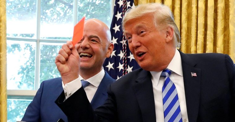 FILE PHOTO: U.S. President Donald Trump holds up a red card as he meets with FIFA President Gianni Infantino in the Oval Office of the White House in Washington, U.S., August 28, 2018. REUTERS/Leah Millis/File Photo