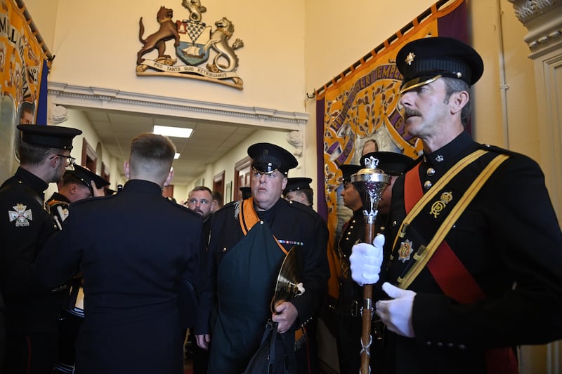 Band members and members of the Orange Order prepare at Clifton Street Orange Hall to parade. Photo: EPA/Shutterstock