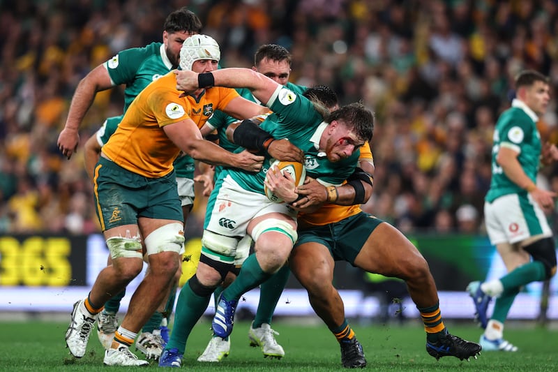 Ireland's Joe McCarthy is tackled by Australia's Allan Alaalatoa and Jeremy Williams. Photograph: Ben Brady/Inpho