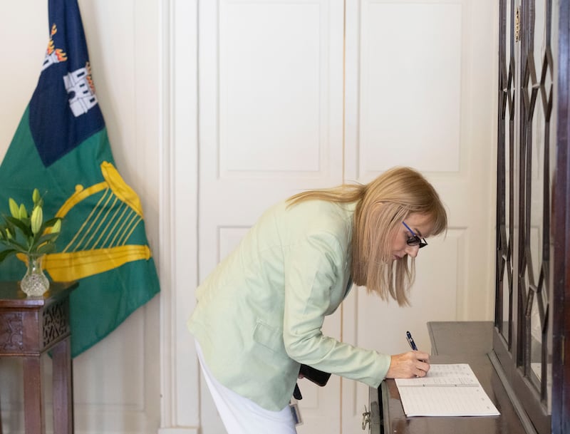Senator Frances Black signs the book of condolences in memory of Glen Hansard in the Mansion House on Thursday. Photograph: Sam Boal/Collins