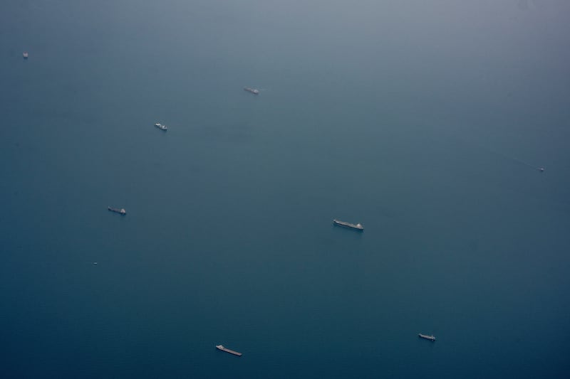 Ships near the Strait of Hormuz, as seen from a plane near the United Arab Emirates. Threats from the Iran-backed Houthi militant group this week to block Saudi Arabia’s use of the Red Sea risk cutting off a crucial alternative path for Mideast oil. Photograph: Tomas Munita/The New York Times
                      