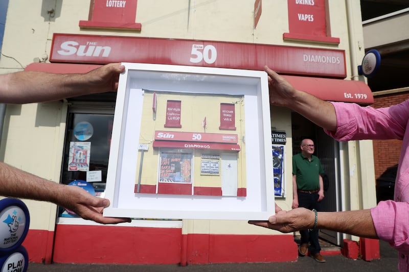 Press photographers present Ballymena Newsagent Eugene Diamond with a replica of his shop front by Dublin artist Nathan Wheeler for years of his dedication to newspapers and photographers.