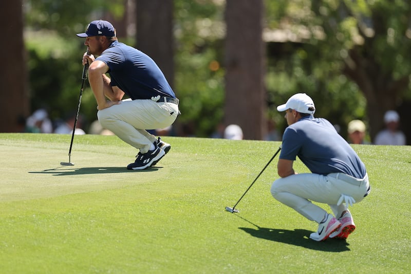 Bryson DeChambeau and Rory McIlroy line up putts on the third green during the final round of the 2025 Masters at Augusta National Golf Club. Photograph: Michael Reaves/Getty Images