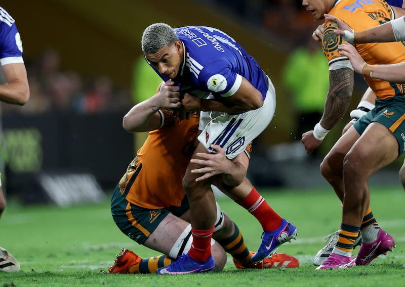Aaron Grandidier-Nkanang is tackled by Australia’s Harry Wilson. Photograph: Billy Stickland/Inpho