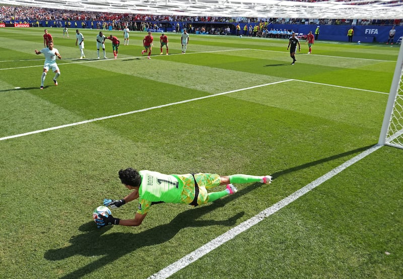 Morocco's Yassine Bounou saves a penalty by France's Kylian Mbappé. Photograph: Lars Baron/Getty Images