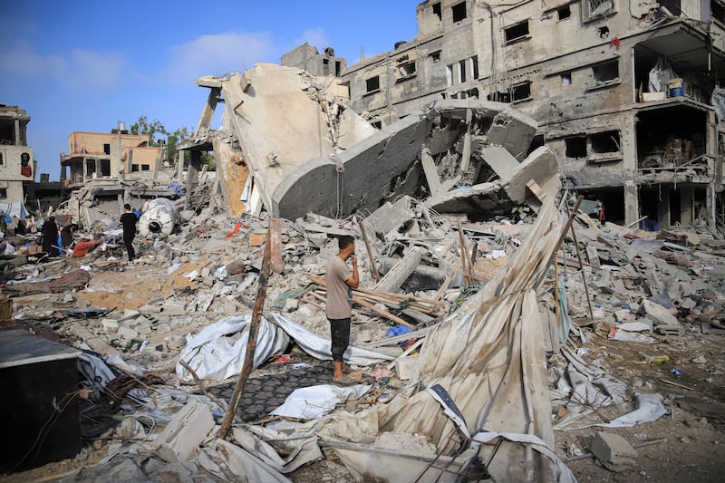 A Palestinian man stands among collapsed concrete, torn tents and scattered belongings after an Israeli air strike in the Al-Nasr neighbourhood of Gaza City on Thursday. Photograph: Mohammed M Skaik/Middle East Images/AFP via Getty Images