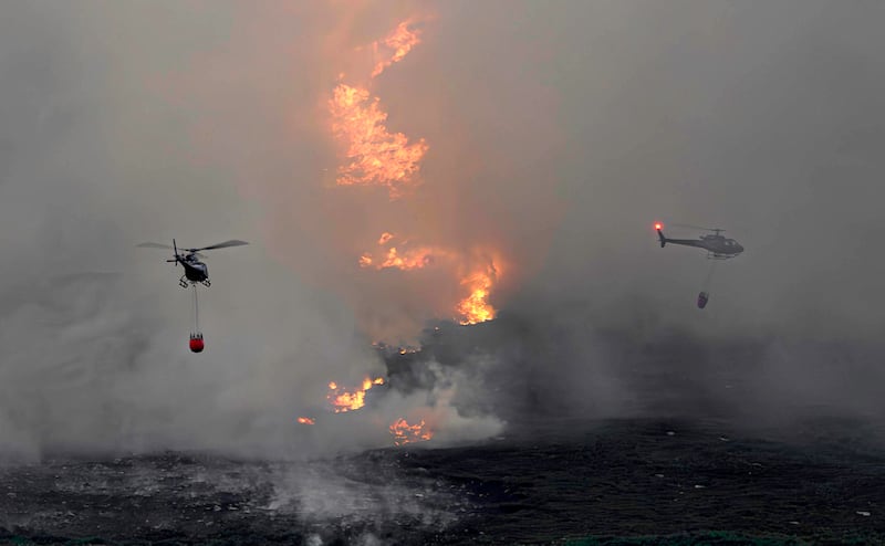 Helicopters drop water on a wildfire on Slievenamon in Co Tipperary. Photograph: Phil Greaves