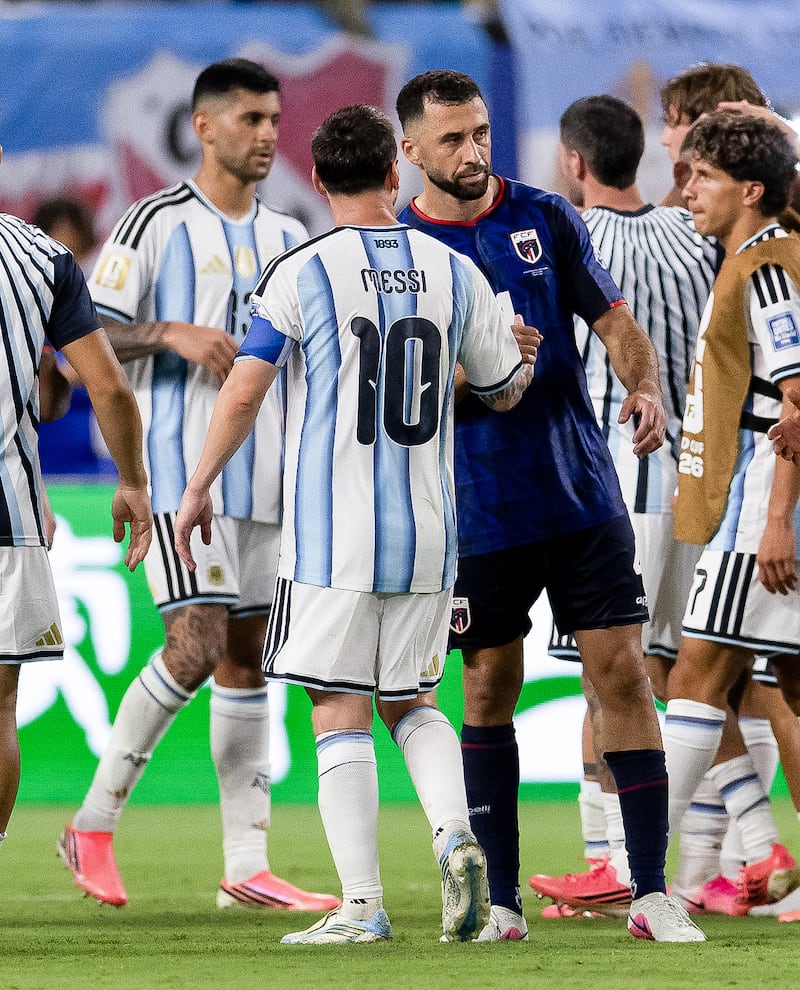 Pico Lopes with Lionel Messi after Cape Verde had been knocked out by the eventual World Cup finalists. Photograph: Inpho
