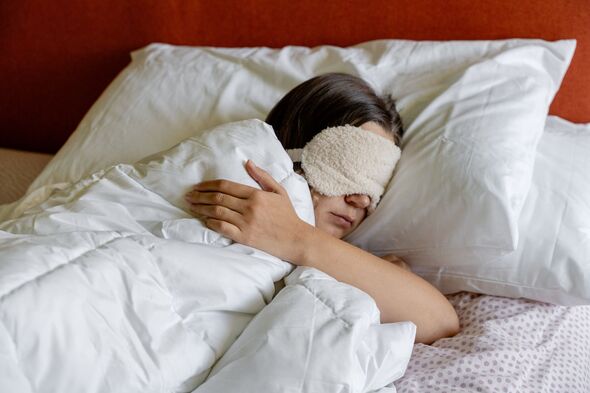 a woman sleeping with a Eye Sleep Mask on her head a woman sleeping with a Eye Sleep Mask on her head
