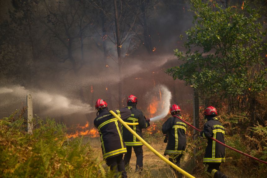 Firefighters battle a wildfire in Lanton, France, on Wednesday.