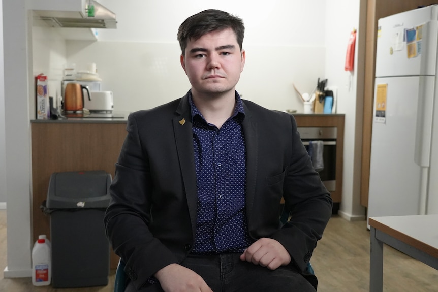 Heath Clark wears black blazer and navy shirt