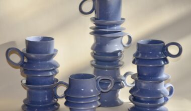 a collection of periwinkle mugs with ripples on their bodies