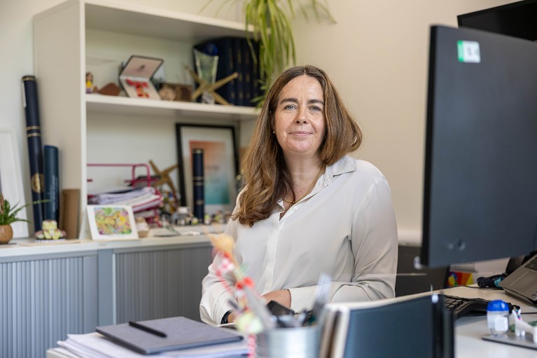 Teresa Lambe seated at her desk in her office.