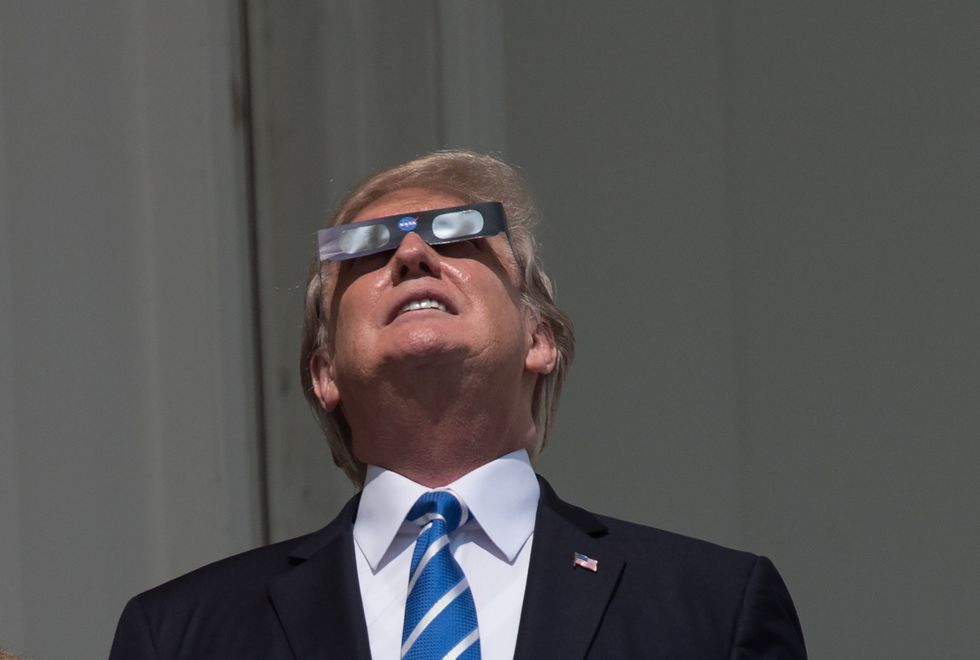 Donald Trump wearing solar eclipse glasses