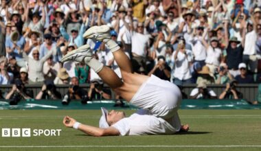 Arthur Fery falls on his back after beating Flavio Cobolli at Wimbledon