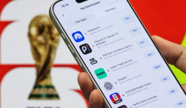 A mock-up image of someone holding a phone looking at Apple App Store's Top Free Apps in front of a poster featuring the FIFA World Cup trophy in the background.