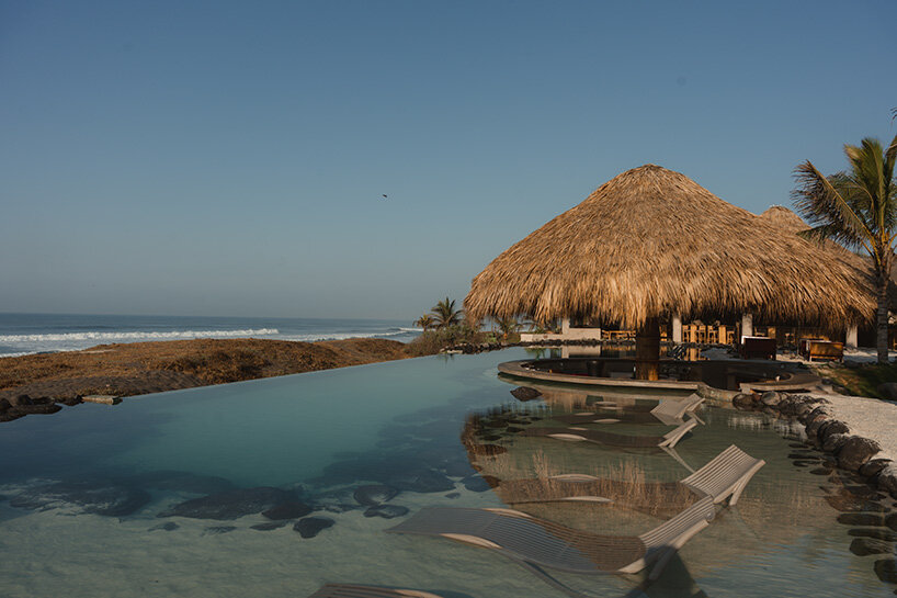 gris shapes naturally cooled beach club around series of open-air pavilions in guatemala - 1