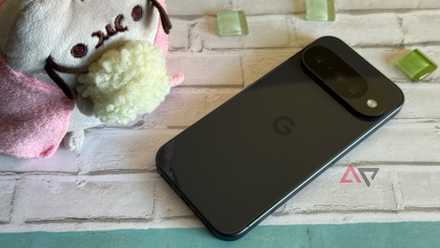 Google Pixel 10 laying next to a Pusheen