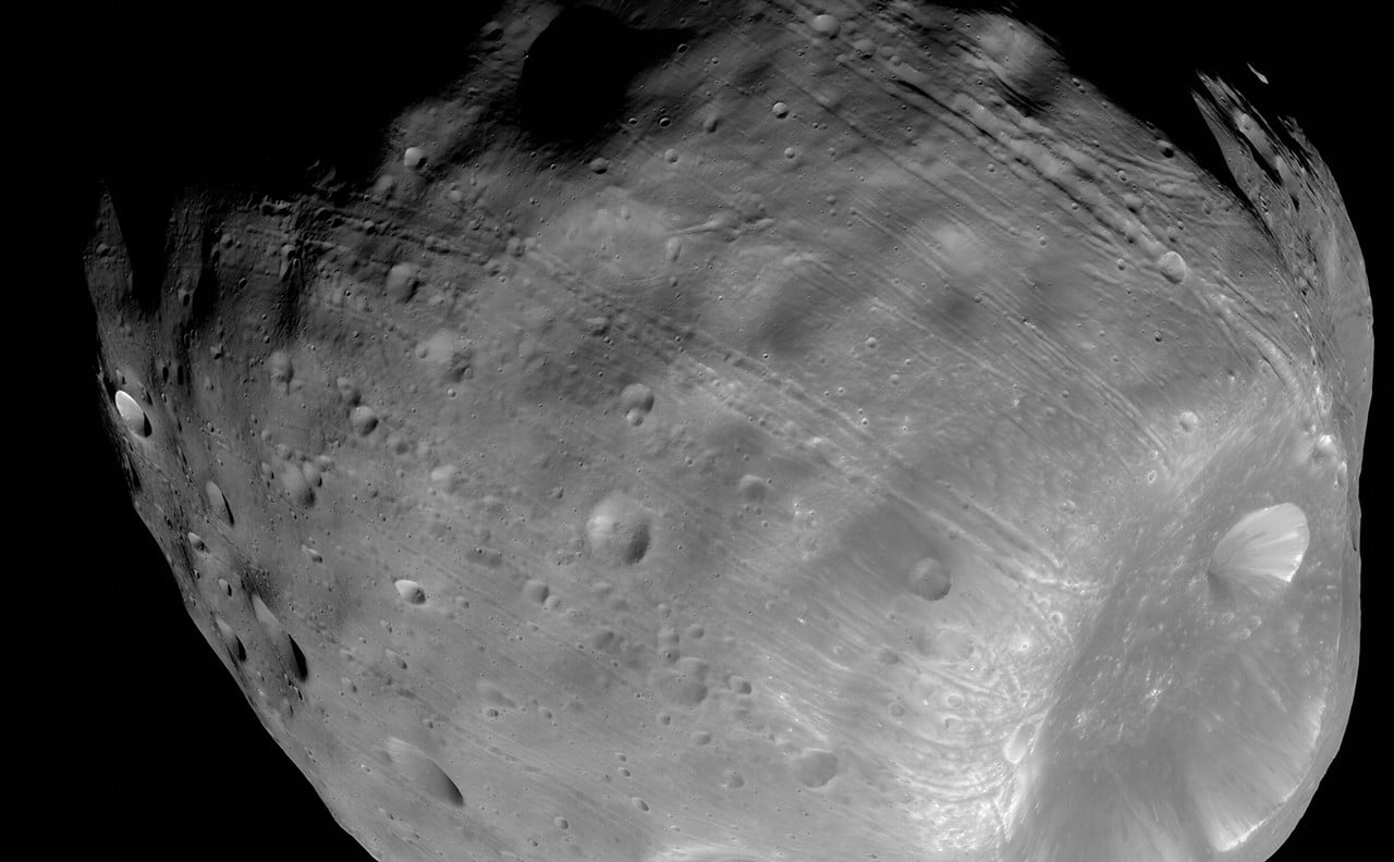 Phobos circles Mars so quickly that it completes more than three orbits per Martian day. Because it outruns the planet’s rotation, it rises in the west and sets in the east—the only known moon whose orbit is shorter than its planet’s day