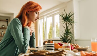 Woman sits at a breakfast table