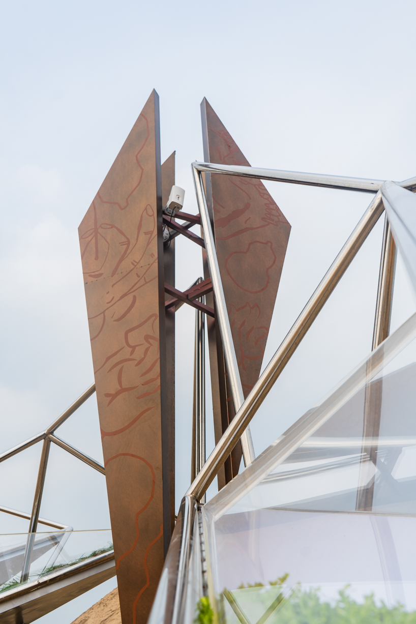 interconnected metal rods form a luminous winged installation on china's coastline - 3