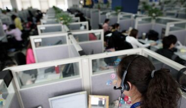 Office workers in cubicles.