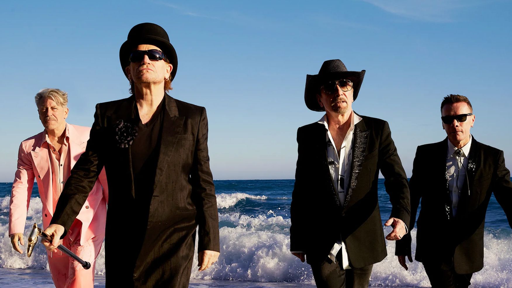 U2 ealking up a beach