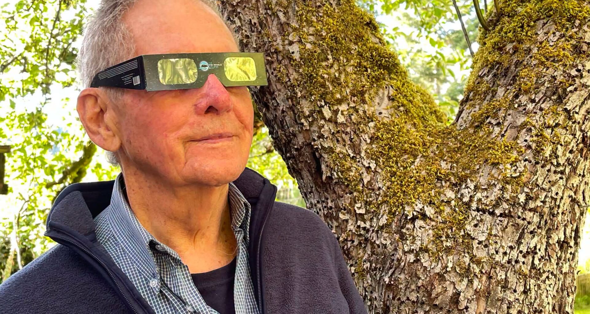 Robert Bateman looking at the sun with special solar eclipse glasses
