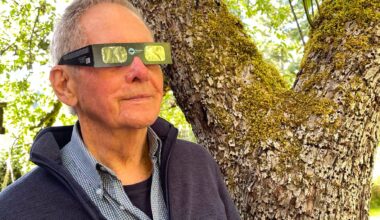 Robert Bateman looking at the sun with special solar eclipse glasses