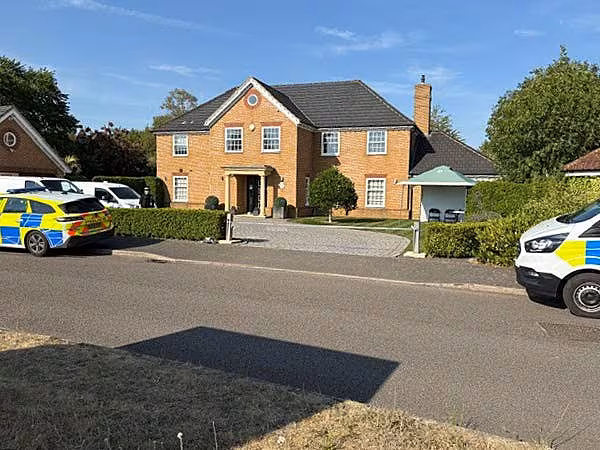 Police vehicles outside a house on Carnoustie Drive, Great Denham