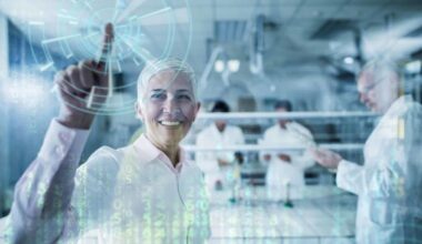 A woman researcher holds a finger up in happiness as if making the 'number one' sign with a graphic of technological data and an orb emanating from her finger while fellow researchers work in the background.