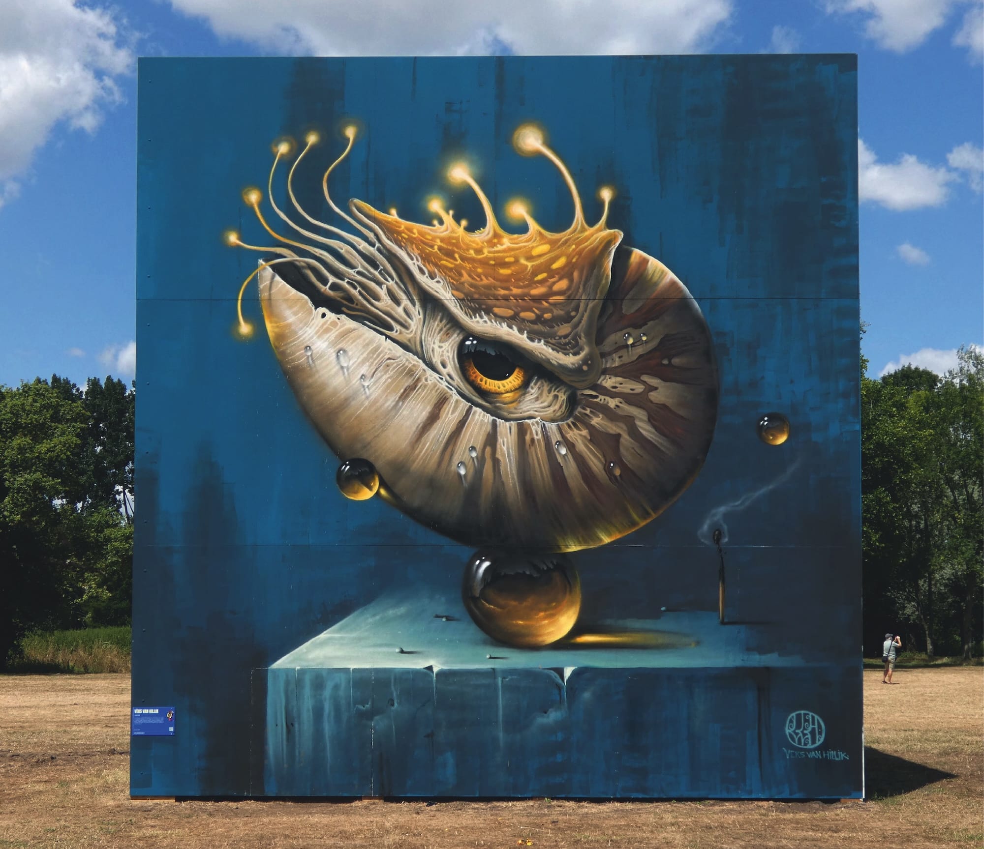 a mural of a nautilus balancing on a pearl-like amber bead on a blue pedestal