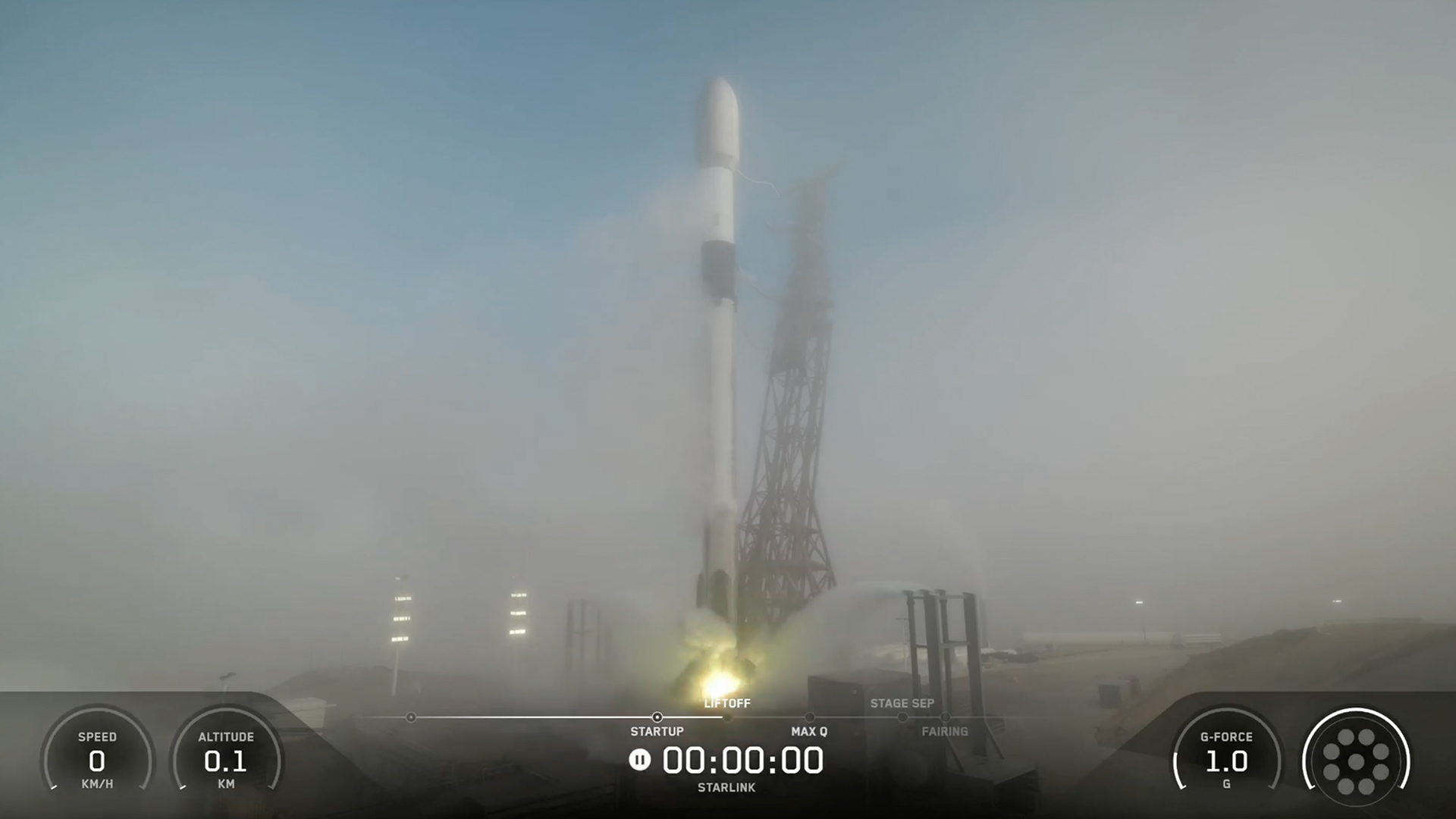 a white rocket upright on a launch pad, partially obscured by fog